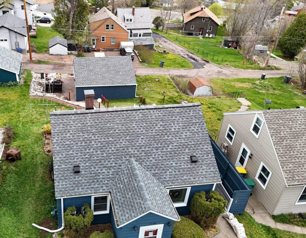 Asphalt shingle roofs on older homes in Hibbing, MN, during a roof inspection by Empire Roofing.