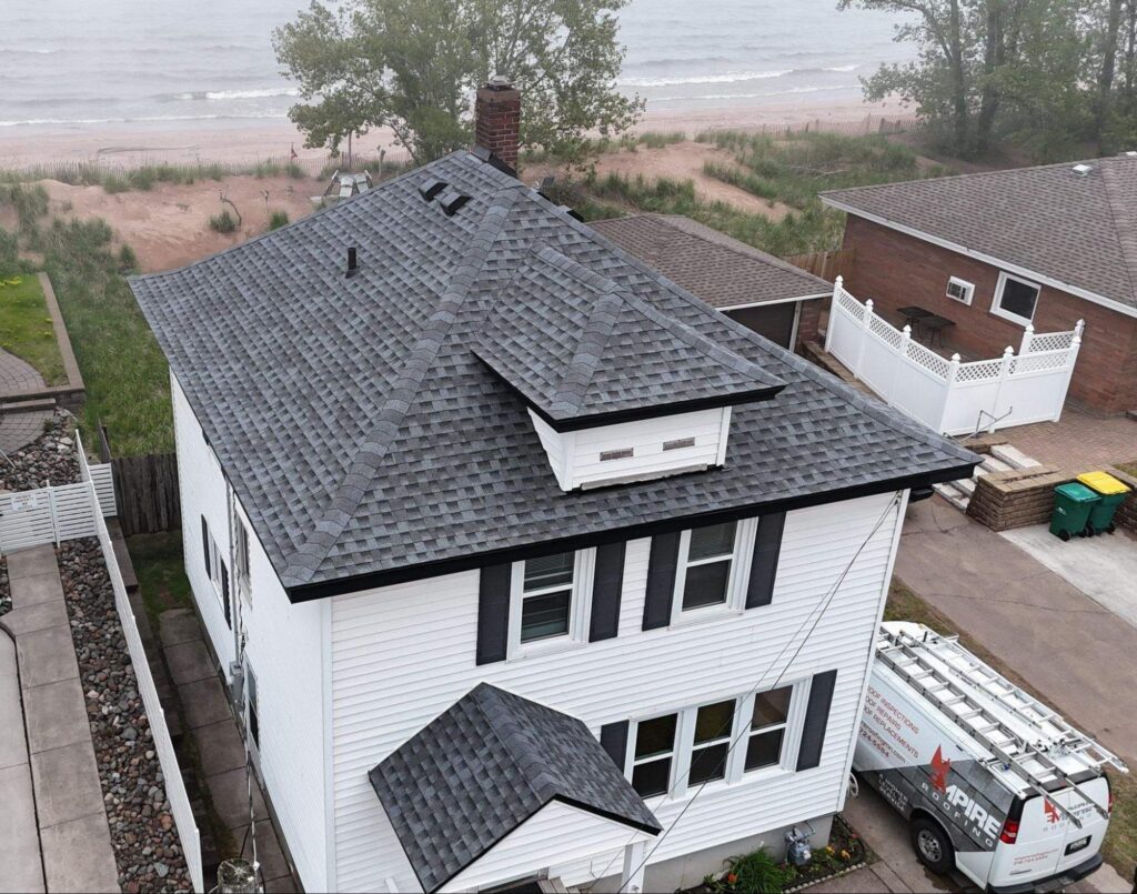 Empire Roofing van beside a shingle roof before a Hermantown, MN roof inspection.