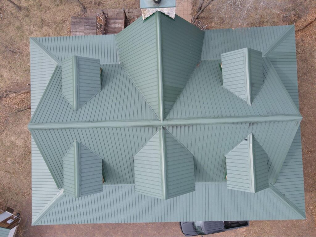 Aerial view of a green metal roof during a roof inspection in Proctor, MN.