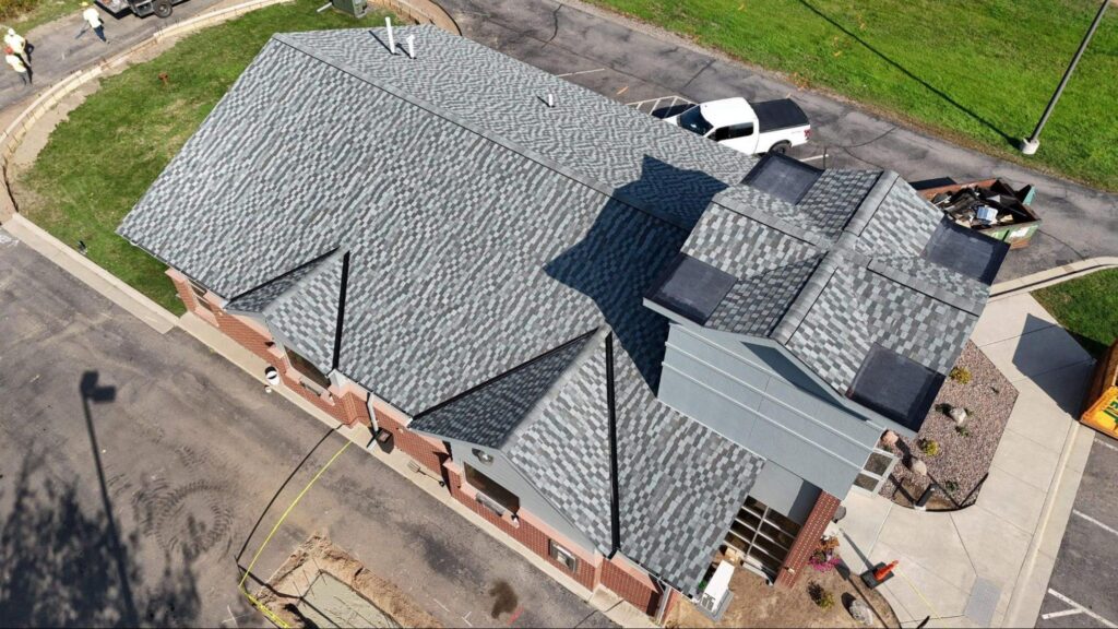 Aerial view of a finished asphalt shingle roof inspection in Rice Lake, MN by Empire Roofing.