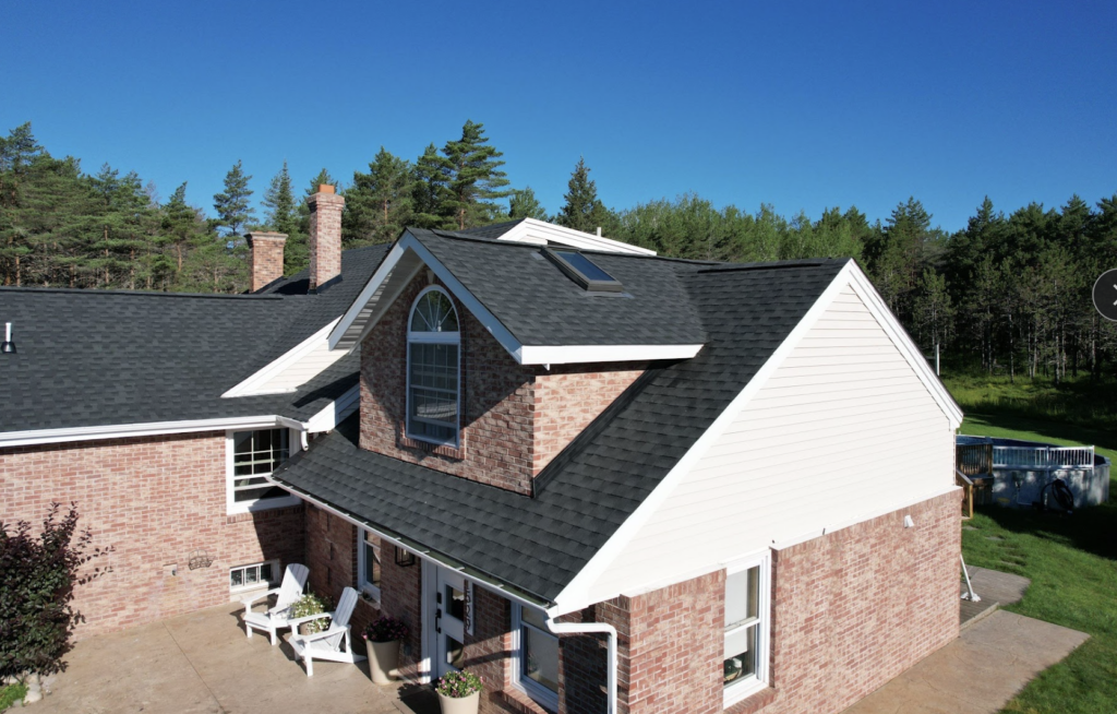 Asphalt shingle roofing on a brick home, where residential roof installation is done in Duluth, MN.